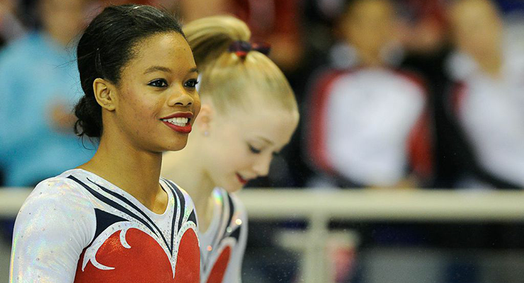 Gabby Douglas smiling at Jesolo competition Bailey Key in the background